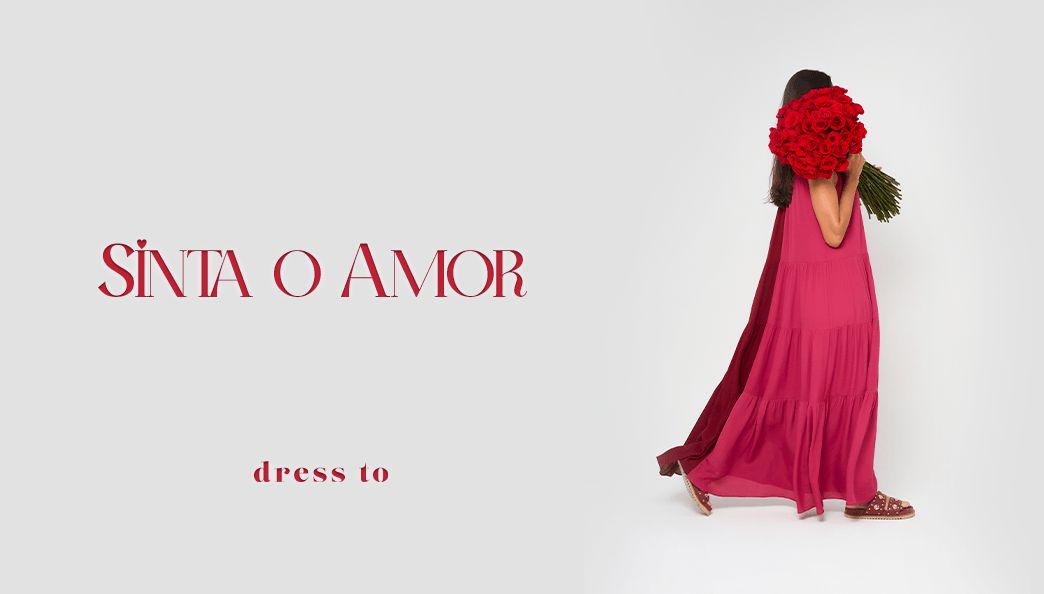 Modelo usando vestido bicolor nas cores rosa e vermelho, segurando rosas vermelhos no banner de fundo branco com o letreiro "sinta o amor" na cor vermelha,  para a campanha de dia dos namorados da Dress To.