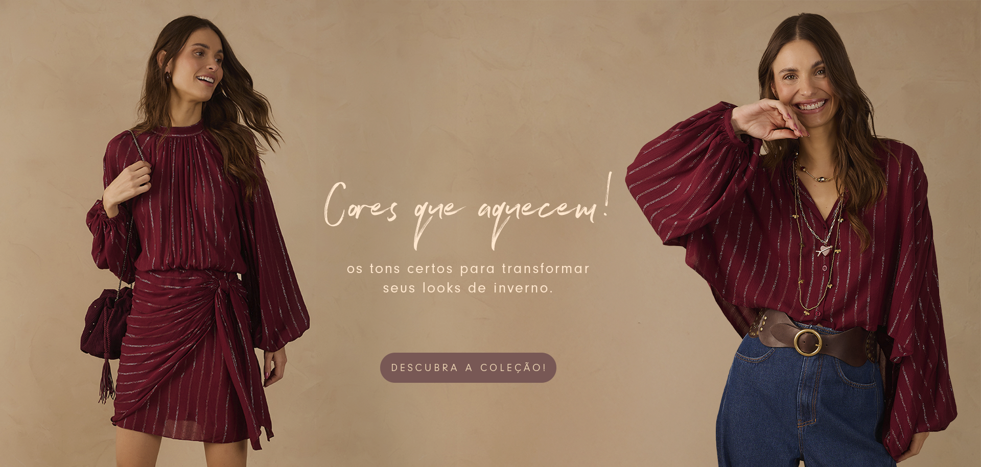 Banner promocional da Dress To com o tema 'Cores que aquecem'. À esquerda, modelo usa vestido curto vinho com brilho e bolsa combinando. À direita, outra modelo veste camisa vinho brilhante com calça jeans de cintura alta e cinto largo marrom. Fundo em tom bege e botão 'Descubra a coleção' ao centro.